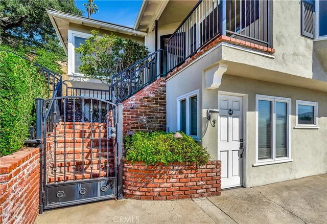 a balcony with furniture and a potted plant