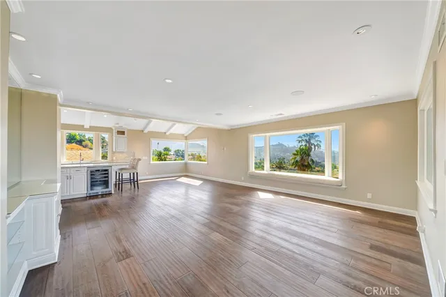 a view of a room that has a large window and front door