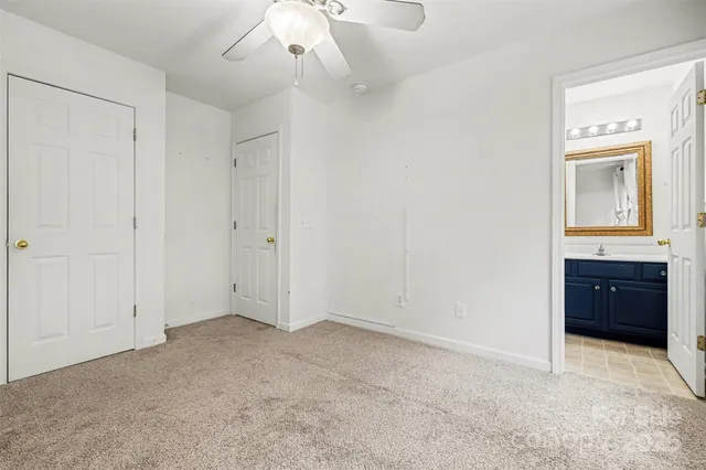 a view of an empty room with a kitchen