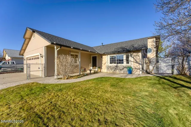 a house view with swimming pool in front of it