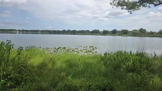 a view of a lake with houses in the back
