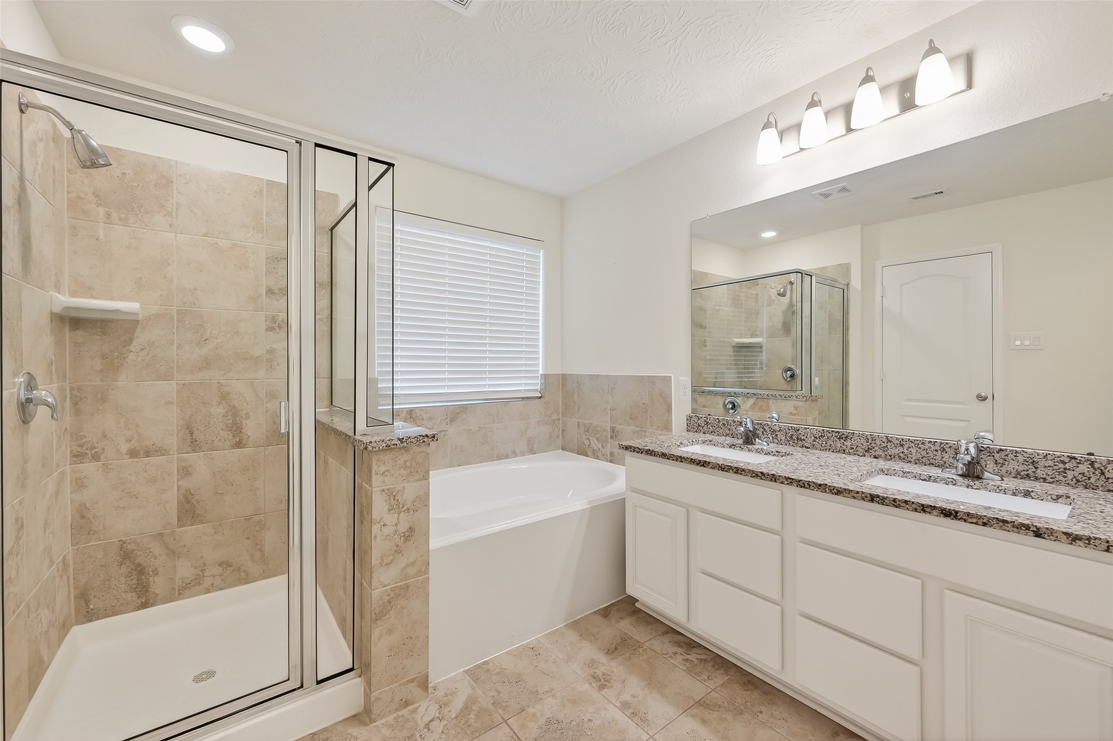 2107 Parnevik Place Conroe, TX 77304 - Photo 26 of 44 The primary ensuite bath features a separate tub and shower
