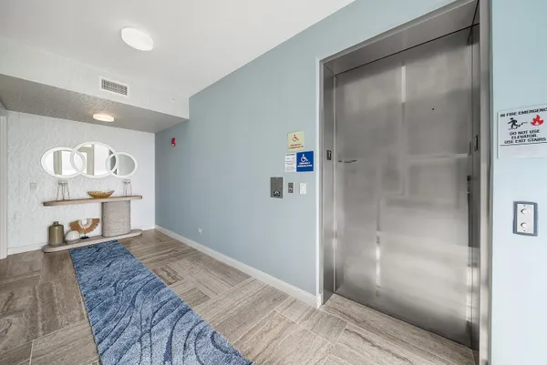 a bedroom with a bed and a glass door shower