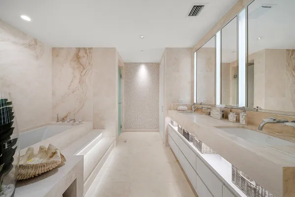 a bathroom with a double vanity sink toilet mirror and shower