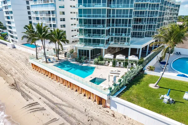 a front view of a building with a garden