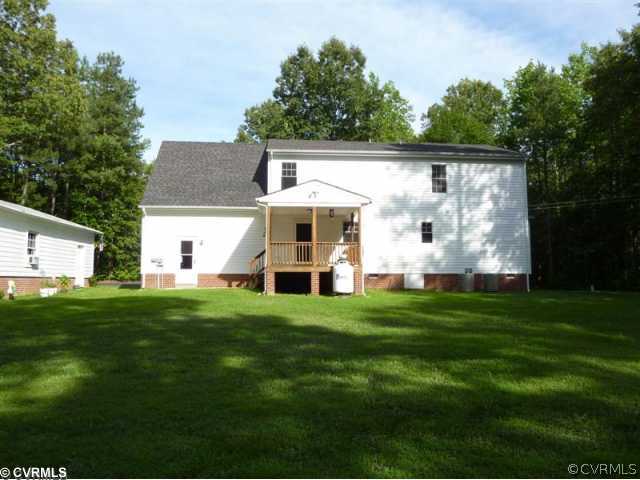 17600 Templeton Road Disputanta, VA 23842 - Photo 4 of 12 a view of a white house in front of a big yard with large trees
