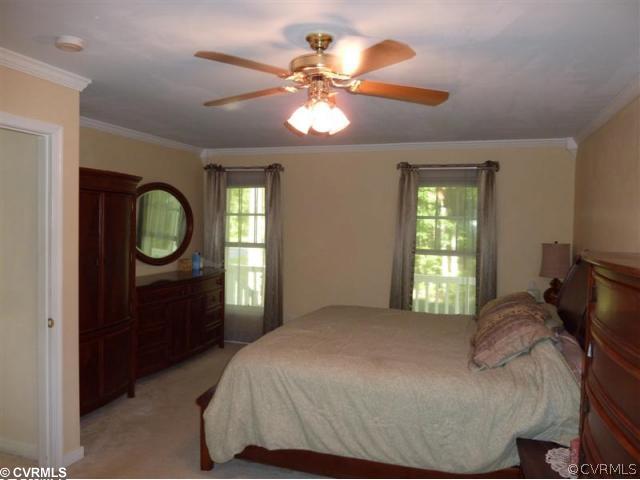 17600 Templeton Road Disputanta, VA 23842 - Photo 8 of 12 a bedroom with a bed and a window