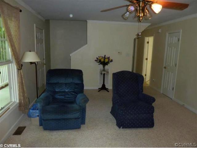 17600 Templeton Road Disputanta, VA 23842 - Photo 10 of 12 a living room with furniture and a chandelier