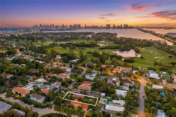 an aerial view of residential houses with city view