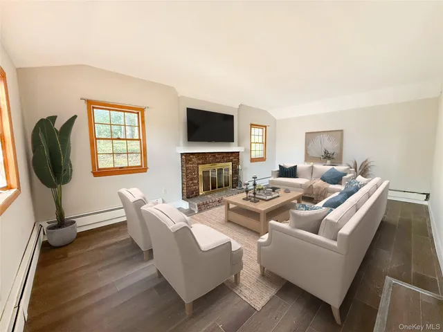 a living room with fireplace furniture and a flat screen tv