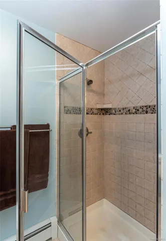 a bathroom with a glass shower door