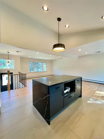 a kitchen with stainless steel appliances granite countertop a sink a oven and a refrigerator
