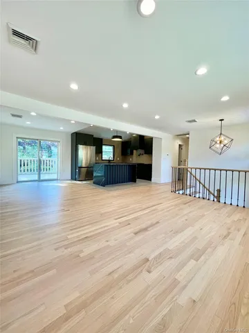 a kitchen with stainless steel appliances granite countertop a refrigerator a sink a stove a microwave and island