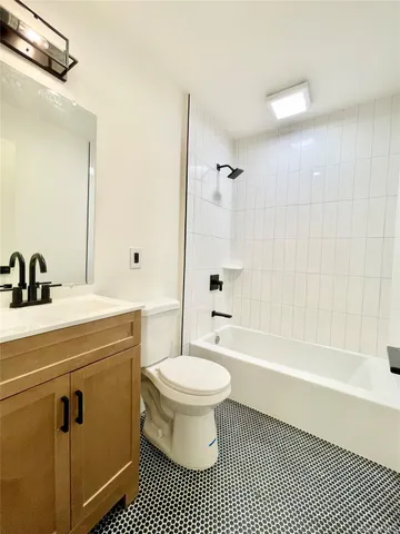 a white toilet sitting next to a bathroom sink