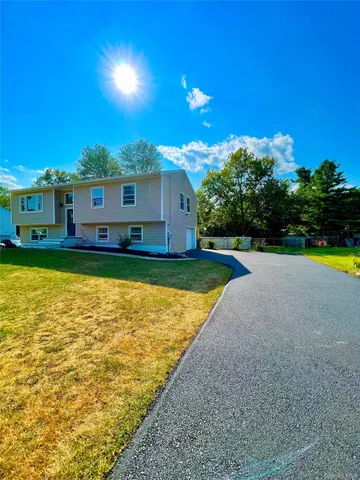 a view of a house with swimming pool and a yard