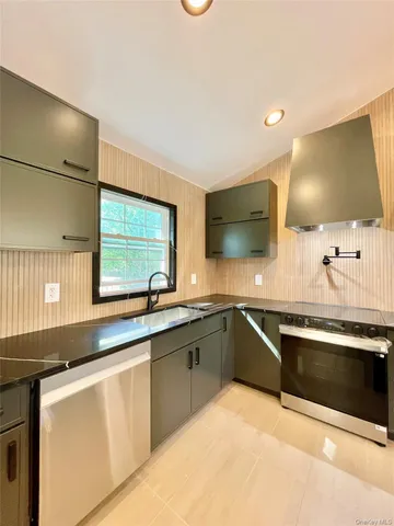 a kitchen with stainless steel appliances a stove and a microwave