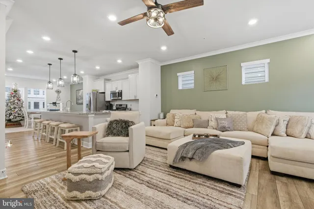 a living room with furniture and a view of kitchen