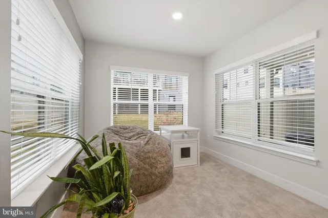 a house with a bed and a large window