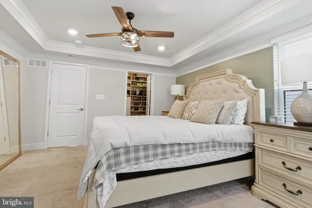 a bedroom with a large bed and a chandelier