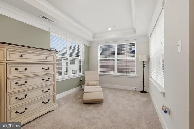 a spacious bedroom with a bed and a window