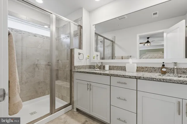 a bathroom with a shower sink and mirror