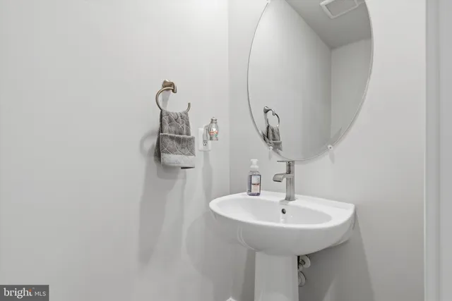 a bathroom with a sink and mirror