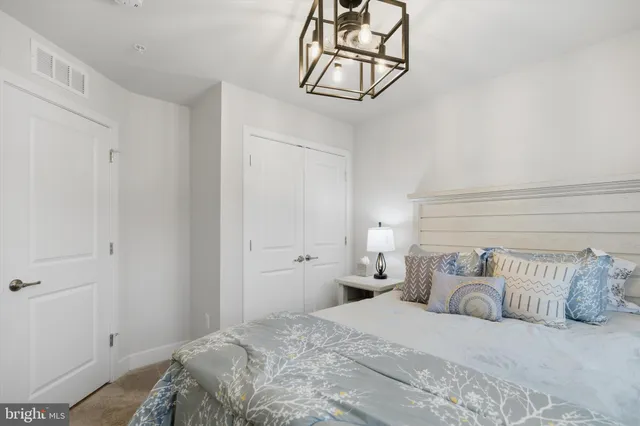 a bedroom with a bed and cabinets