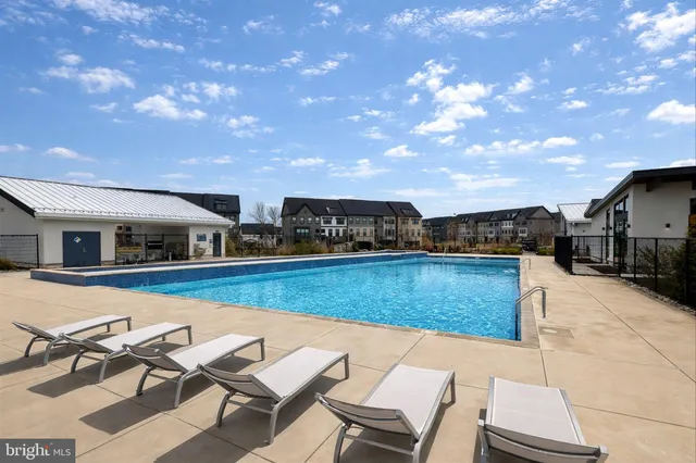a swimming pool with outdoor seating and yard
