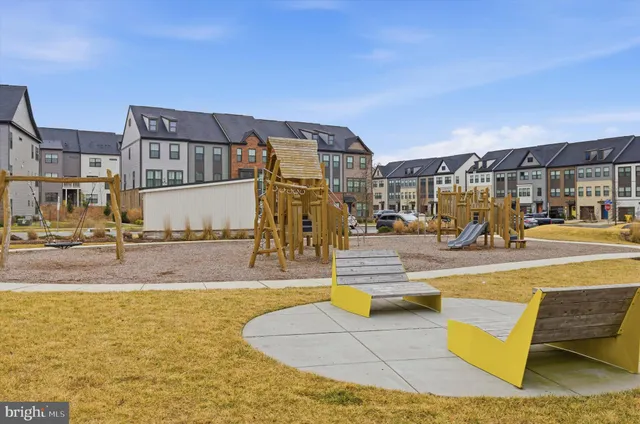 a view of swimming pool with table and chairs