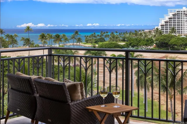 a view of a balcony with furniture and a garden