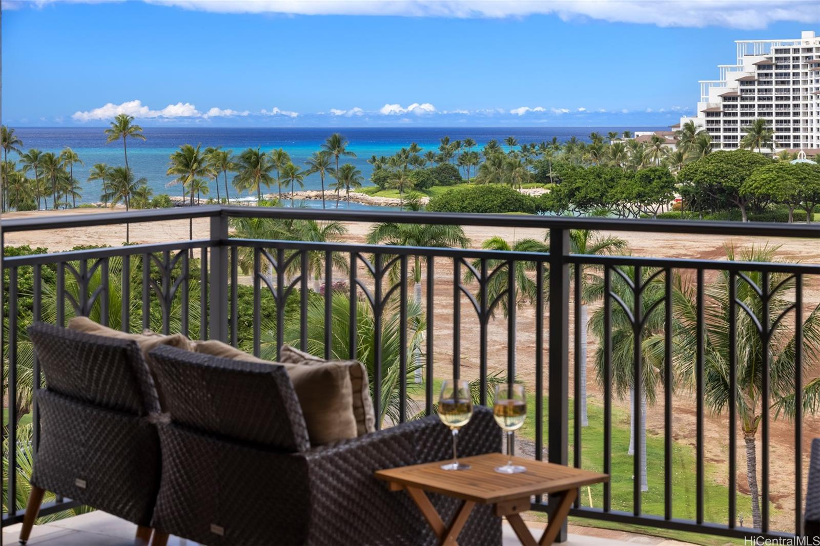 a view of a balcony with furniture and a garden