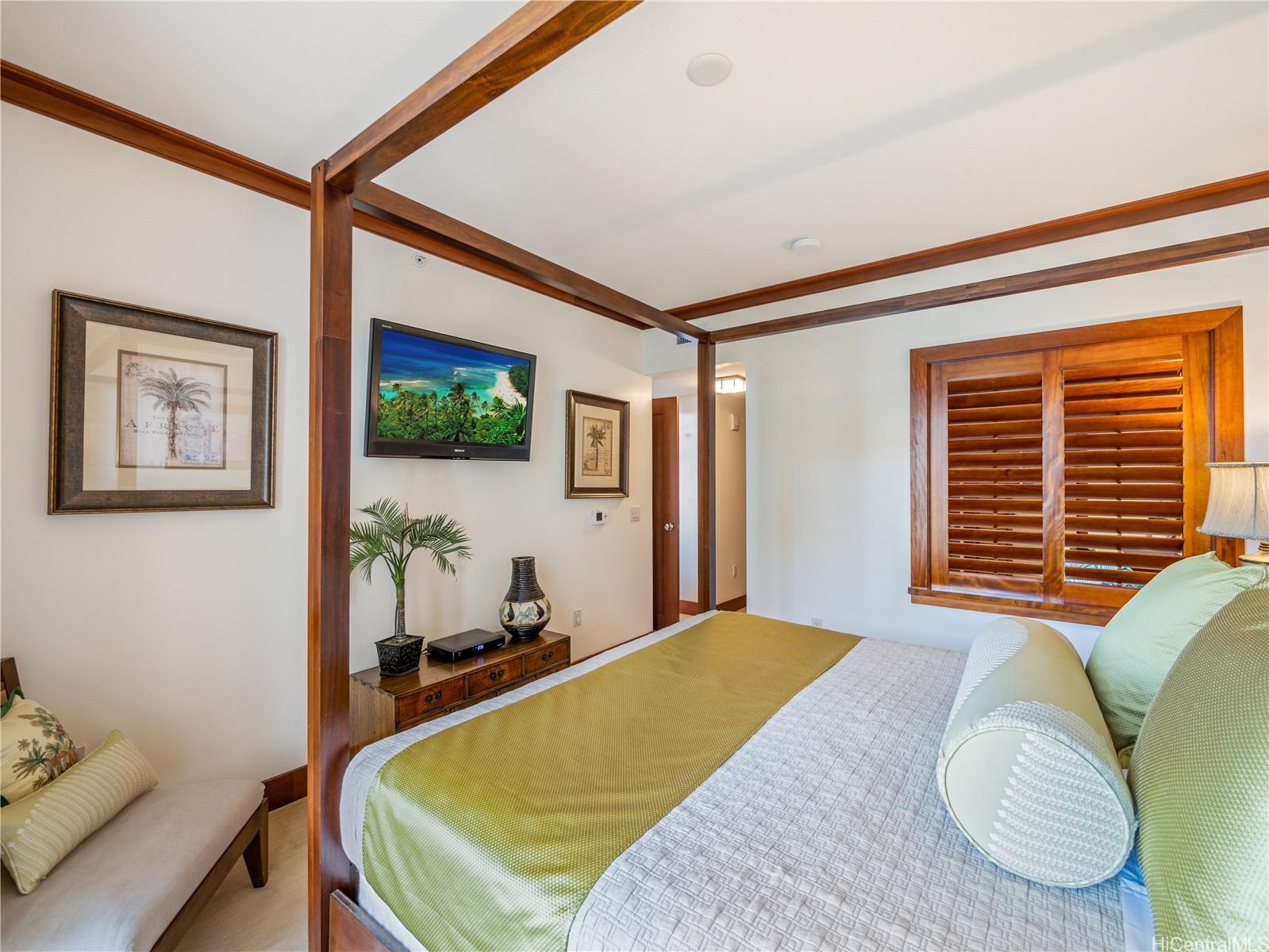 92-104 Waialii Place, Unit O712 Kapolei, HI 96707 - Photo 11 of 25 a bedroom with a bed and a flat screen tv