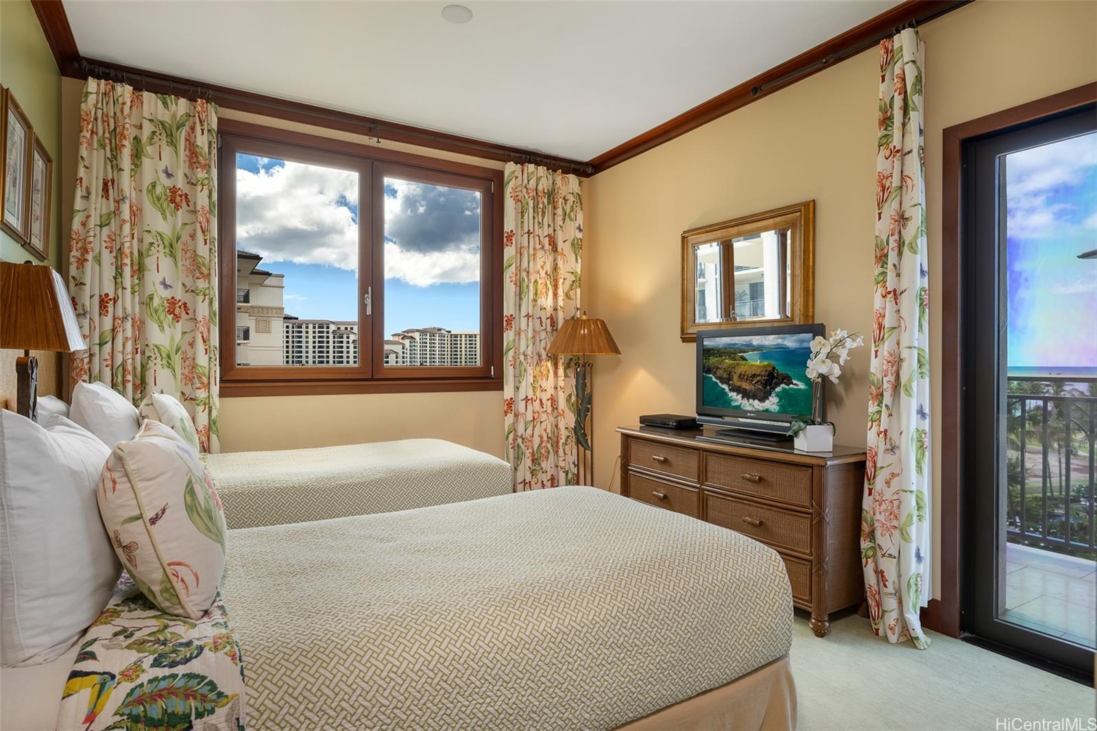 92-104 Waialii Place, Unit O712 Kapolei, HI 96707 - Photo 15 of 25 a bedroom with a large bed and a window