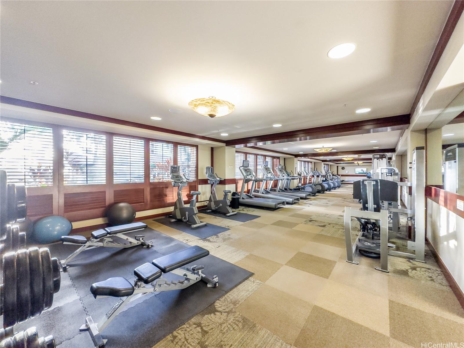 92-104 Waialii Place, Unit O712 Kapolei, HI 96707 - Photo 17 of 25 a room with gym equipment and large windows