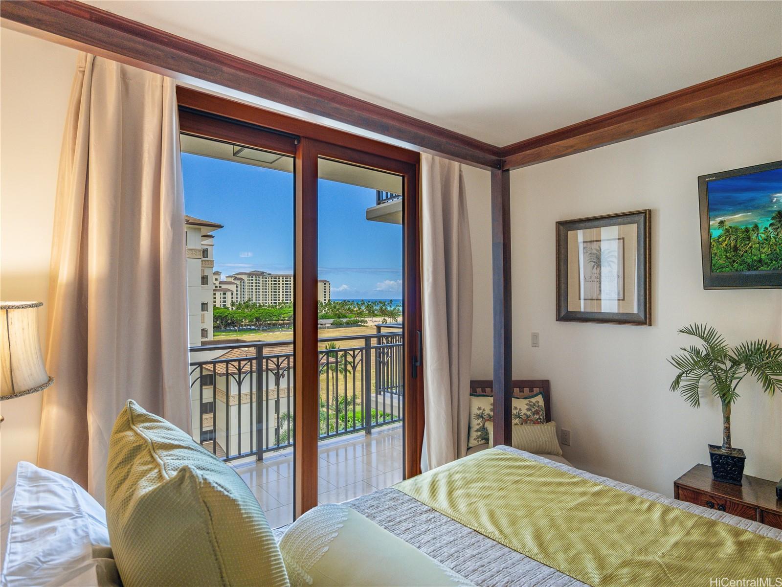 92-104 Waialii Place, Unit O712 Kapolei, HI 96707 - Photo 10 of 25 a bedroom with a large bed and a potted plant