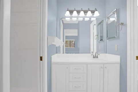 a bathroom with a sink and a mirror