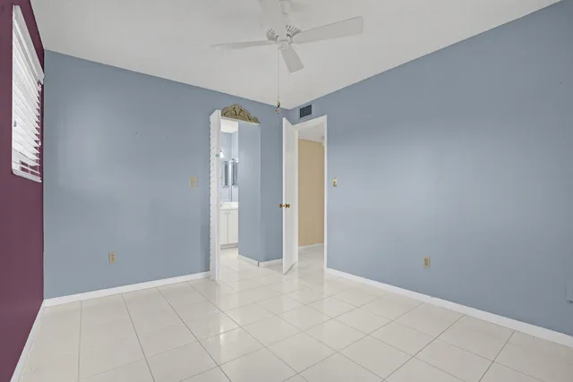 a view of a room with a chandelier fan and closet