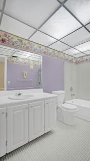 a bathroom with a sink a toilet and bathtub