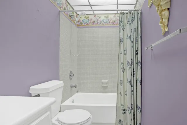 a bathroom with a shower a toilet and a sink