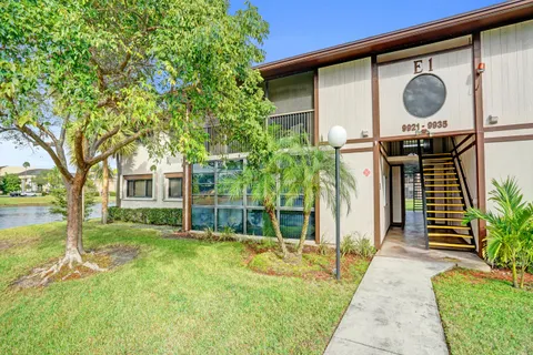 a view of a house with a small yard and plants
