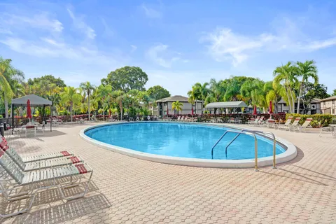 a view of a swimming pool with an outdoor seating