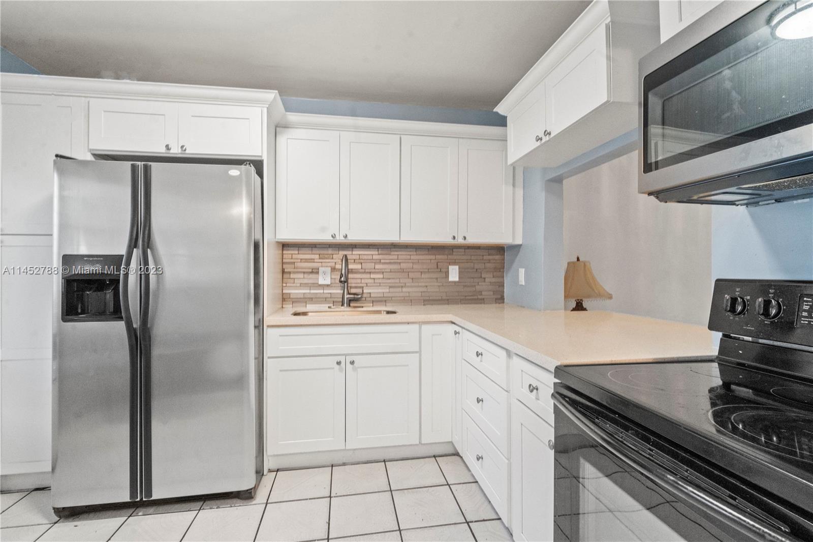 Norland Miami, FL 33179 - Photo 4 of 15 a kitchen with a refrigerator sink and cabinets