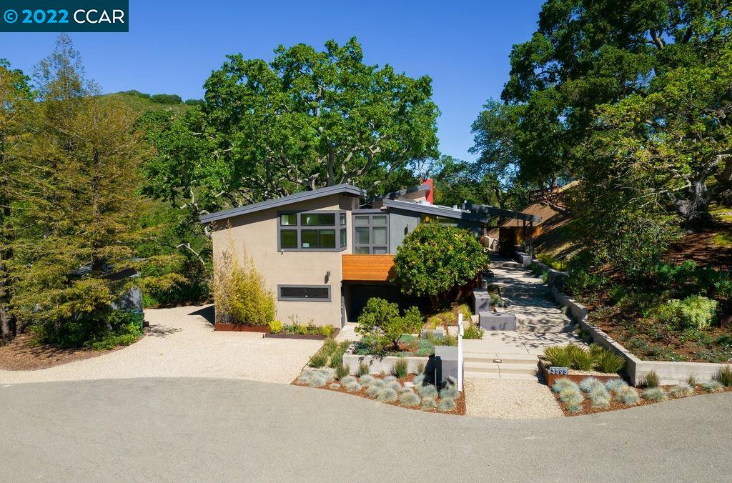 3595 Echo Springs Road Lafayette, CA 94549 - Photo 1 of 1 a backyard of a house with table and chairs plants and large trees