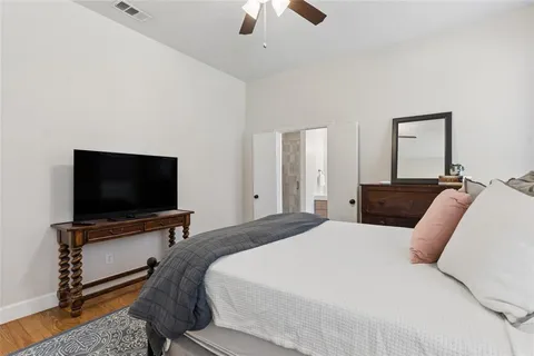a bedroom with a bed and a flat screen tv