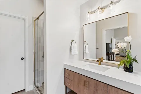 a bathroom with a double vanity sink and a mirror
