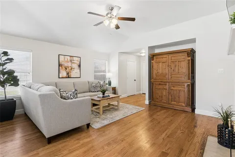 a living room with furniture and wooden floor