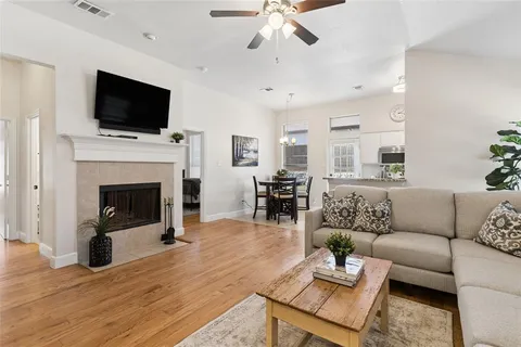 a living room with furniture a fireplace and a flat screen tv