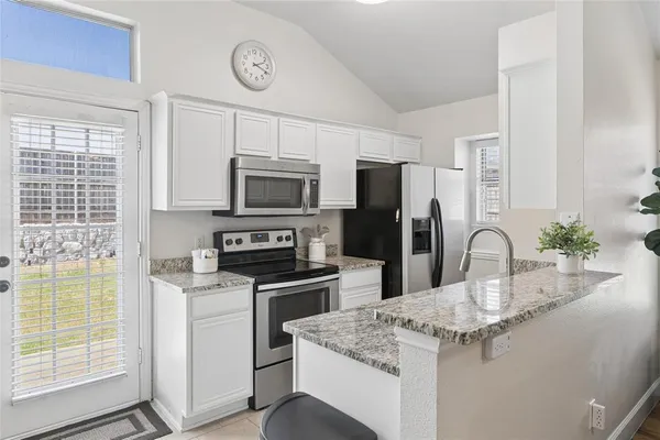 a kitchen with a sink appliances and cabinets