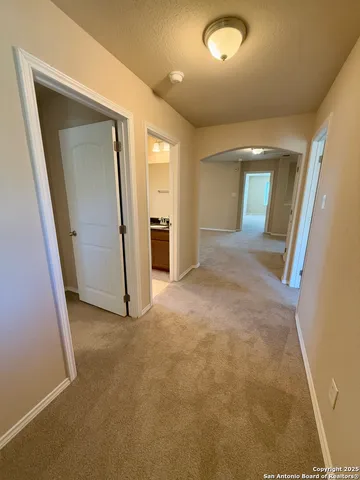 an empty room with a ceiling fan and window