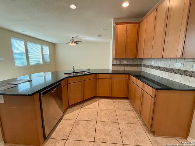 a kitchen with stainless steel appliances granite countertop a sink and cabinets